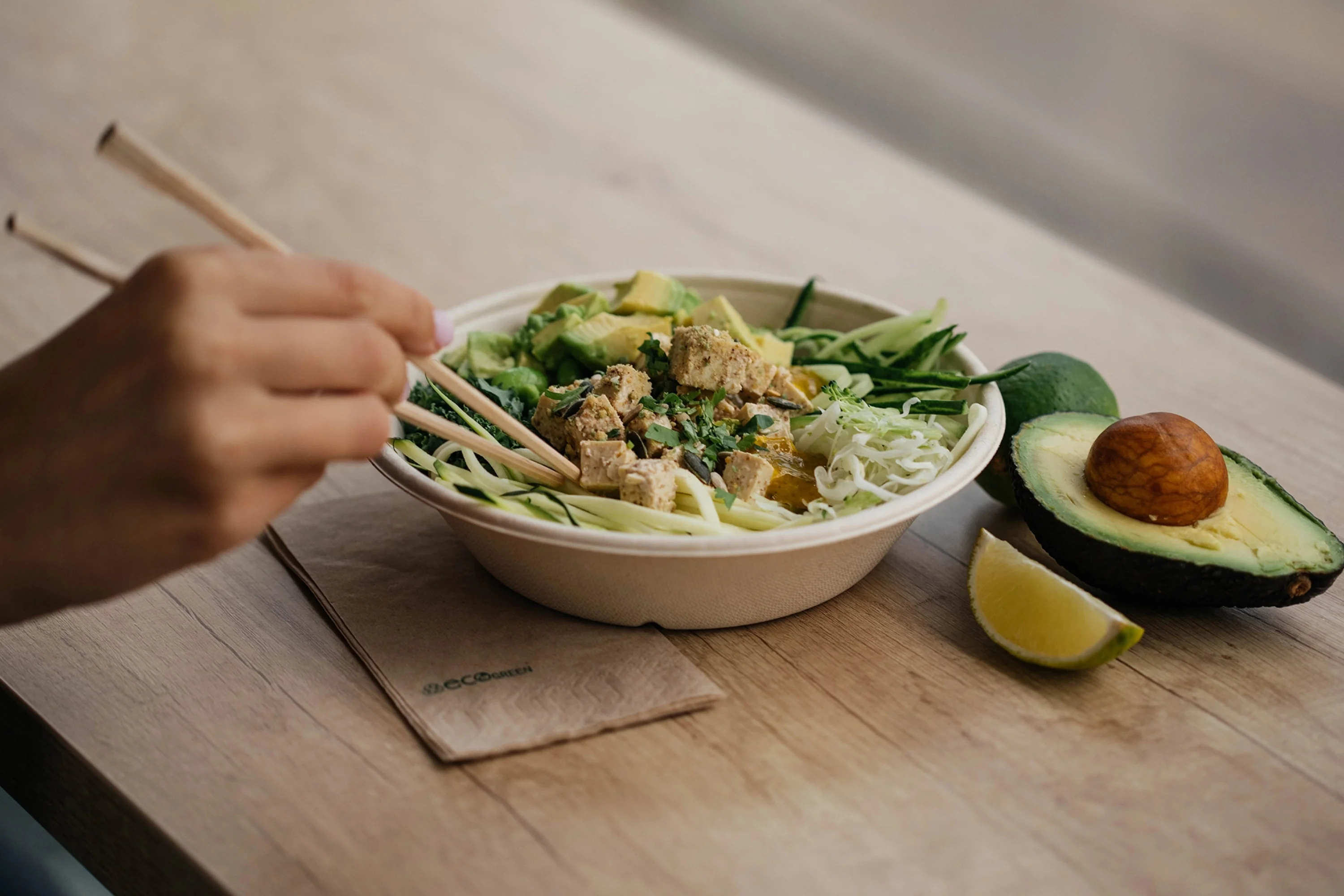 a salad in a bowl with chopsticks